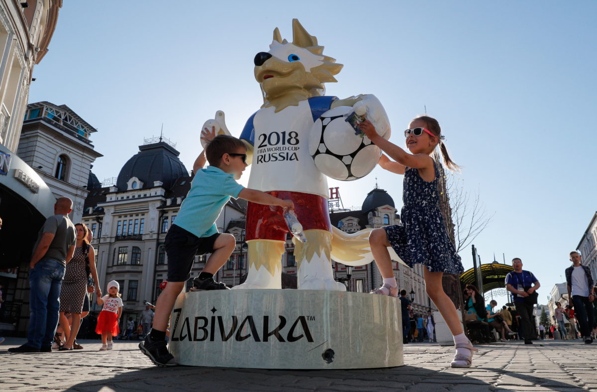 Children play around the FIFA World Cup official mascot Zabivaka